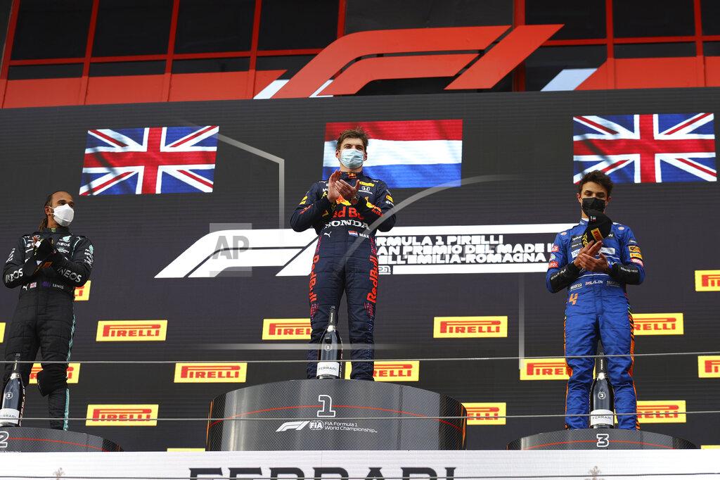 Bryn Lennon From left, second placed Mercedes Lewis Hamilton, first placed Red Bull's Max Verstappen and third placed McLaren's Lando Norris celebrate on the podium at the end of the Emilia Romagna Formula One Grand Prix, at the Imola racetrack, Italy, Sunday, April 18, 2021. (Bryn Lennon/ Pool Via AP)