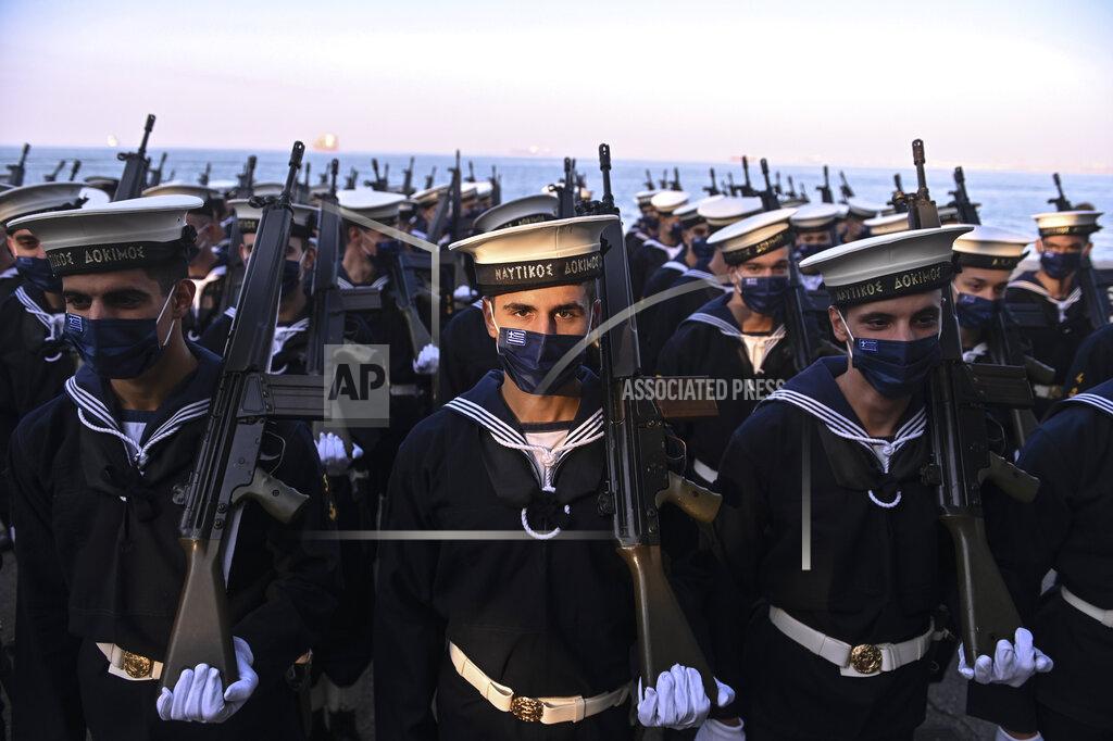 Giannis Papanikos Greek soldiers prepare to take part in the military parade at the northern port city of Thessaloniki, Greece, Thursday, Oct. 28, 2021. The parade is held to celebrate Greece's refusal to align itself with a belligerent fascist Italy in 1940 and instead fight a much stronger opponent, a decision which dragged it into World War II and eventually led to a brutal occupation by Nazi Germany. (AP Photo/Giannis Papanikos)