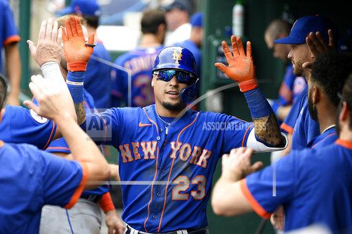 FILE - New York Mets' Javier Baez celebrates his home run in the dugout during the third inning of a baseball game against the Washington Nationals, Sunday, Sept. 5, 2021, in Washington. Javier Baez is nearing a $140 million, six-year contract with Detroit, giving the Tigers a dynamic bat for the middle of their order. Baez, who turns 29 on Wednesday, hit .265 with 31 homers and 87 RBIs in 138 games with the Cubs and Mets last season. A person with direct knowledge of the situation confirmed the deal to The Associated Press on Tuesday, Nov. 30, on condition of anonymity because the contract had not been finalized. (AP Photo/Nick Wass, File)