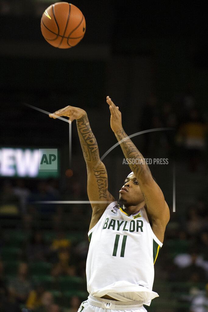 Emil Lippe Baylor guard James Akinjo (11) shoots a three-pointer in the first half of an NCAA college basketball game against Arkansas Pine Bluff in Waco, Texas, Saturday, Dec. 4, 2021. (AP Photo/Emil Lippe)