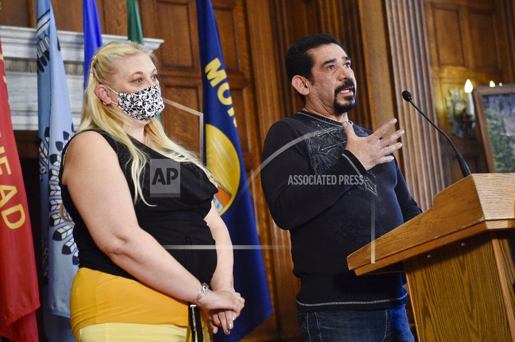 Butte resident Gilbert Herrera, right, tells the story of his battle with COVID-19 on Thursday, Oct. 29, 2020, during a press call hosted by Gov. Steve Bullock at the state Capitol in Helena, Mont.. Also pictured is Herrera's wife, Gina Sandon, who was also hospitalized for Covid-19.(Thom Bridge/Independent Record via AP)