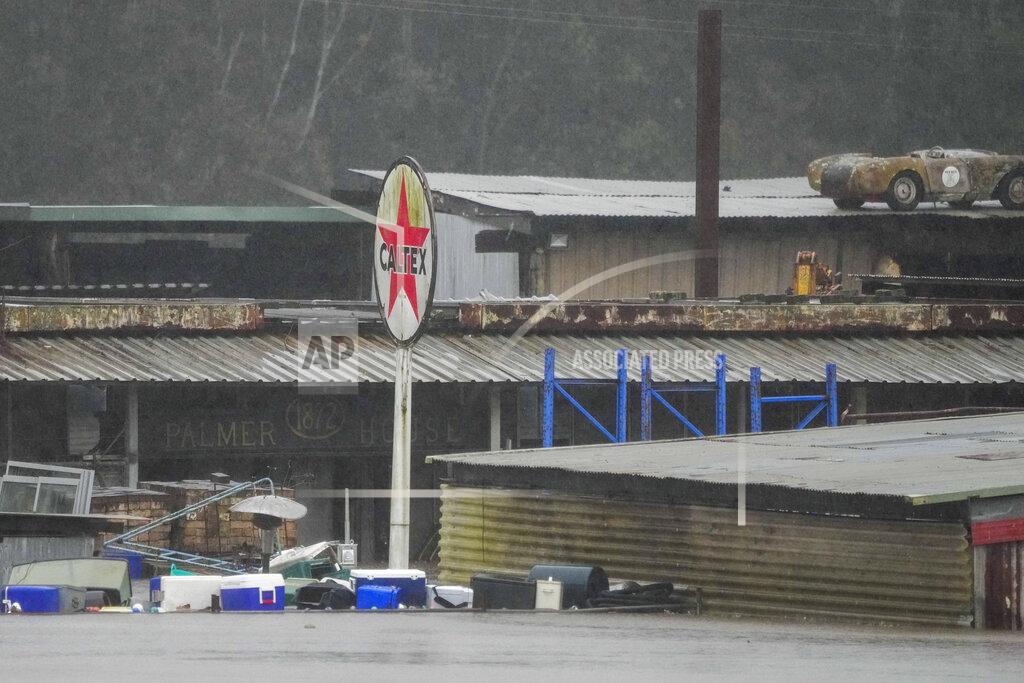 Mark Baker Flood waters surround an industrial property in Londonderry on the outskirts of Sydney, Australia, Monday, July 4, 2022. More than 30,000 residents of Sydney and its surrounds have been told to evacuate or prepare to abandon their homes on Monday as Australia's largest city braces for what could be its worst flooding in 18 months. (AP Photo/Mark Baker)