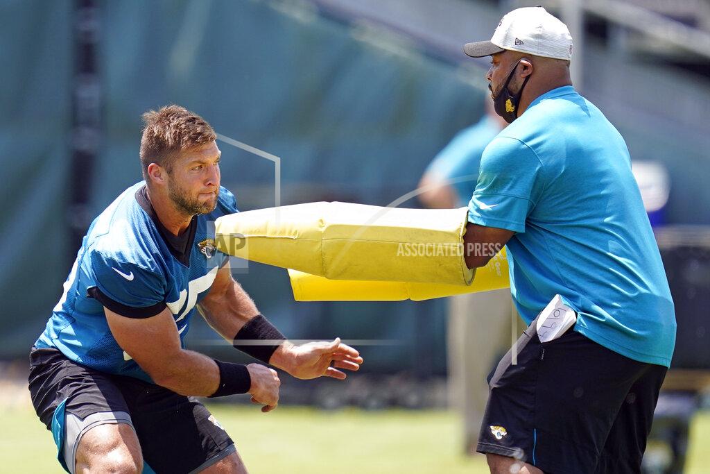 John Raoux Jacksonville Jaguars tight end Tim Tebow, left, performs a drill during NFL football practice, Thursday, May 27, 2021, in Jacksonville, Fla. (AP Photo/John Raoux)