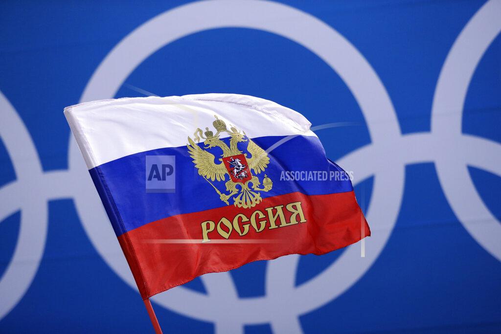 Matt Slocum FILE - In this Saturday, Feb. 17, 2018 file photo Russian supporter waves a flag before the preliminary round of the men's hockey game between the team from Russia and the United States at the 2018 Winter Olympics in Gangneung, South Korea. Russia was banned Thursday Dec. 17, 2020 from using its name, flag and anthem at the next two Olympics or at any world championships for the next two years. The Court of Arbitration for Sport's ruling also blocked Russia from bidding to host major sporting events for two years. (AP Photo/Matt Slocum, File)
