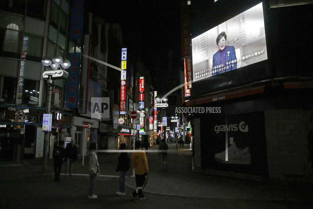 Kiichiro Sato In this April 25, 2020, photo, people walk through the entertainment district near Shibuya station right before the 8pm government requested closing time for restaurants and bars in Tokyo, as Tokyo governor Yuriko Koike's recorded video message urges people to stay home. Under Japan's coronavirus state of emergency, people have been asked to stay home. Many are not. Some still have to commute to their jobs despite risks of infection, while others are dining out, picnicking in parks and crowding into grocery stores with scant regard for social distancing. (AP Photo/Kiichiro Sato)
