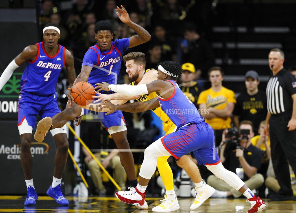 Charlie Neibergall Iowa guard Jordan Bohannon, center, drives between DePaul's Romeo Weems (1) and Markese Jacobs, right, during the first half of an NCAA college basketball game, Monday, Nov. 11, 2019, in Iowa City, Iowa. (AP Photo/Charlie Neibergall)