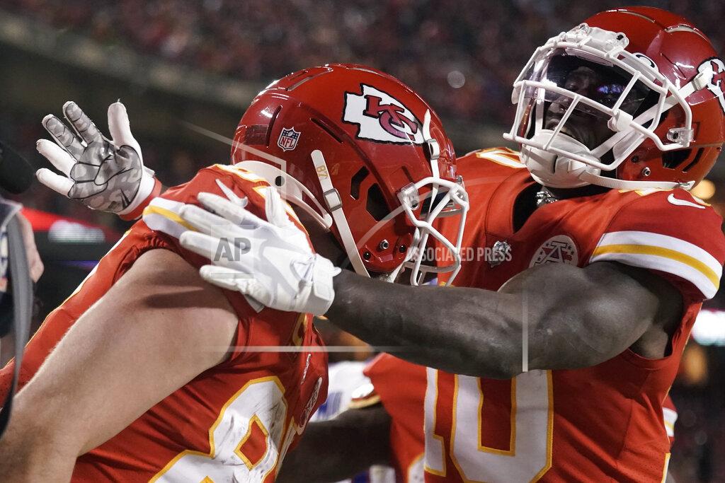 Charlie Riedel Kansas City Chiefs tight end Travis Kelce, left, celebrates with teammate Tyreek Hill (10) after catching an 8-yard touchdown pass during overtime in an NFL divisional round playoff football game against the Buffalo Bills, Sunday, Jan. 23, 2022, in Kansas City, Mo. The Chiefs won 42-36. (AP Photo/Charlie Riedel)