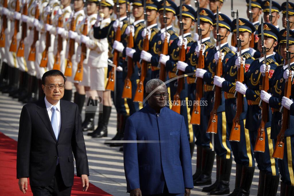 Mark Schiefelbein FILE - Chinese Premier Li Keqiang, left, and Solomon Islands Prime Minister Manasseh Sogavare review an honor guard during a welcome ceremony at the Great Hall of the People in Beijing, on Oct. 9, 2019. When China signed a security pact with the Solomon Islands in April, 2022, it raised concerns from the U.S. and its allies that Beijing may be seeking a military outpost in the South Pacific, an area of traditional American naval dominance. (AP Photo/Mark Schiefelbein, File)