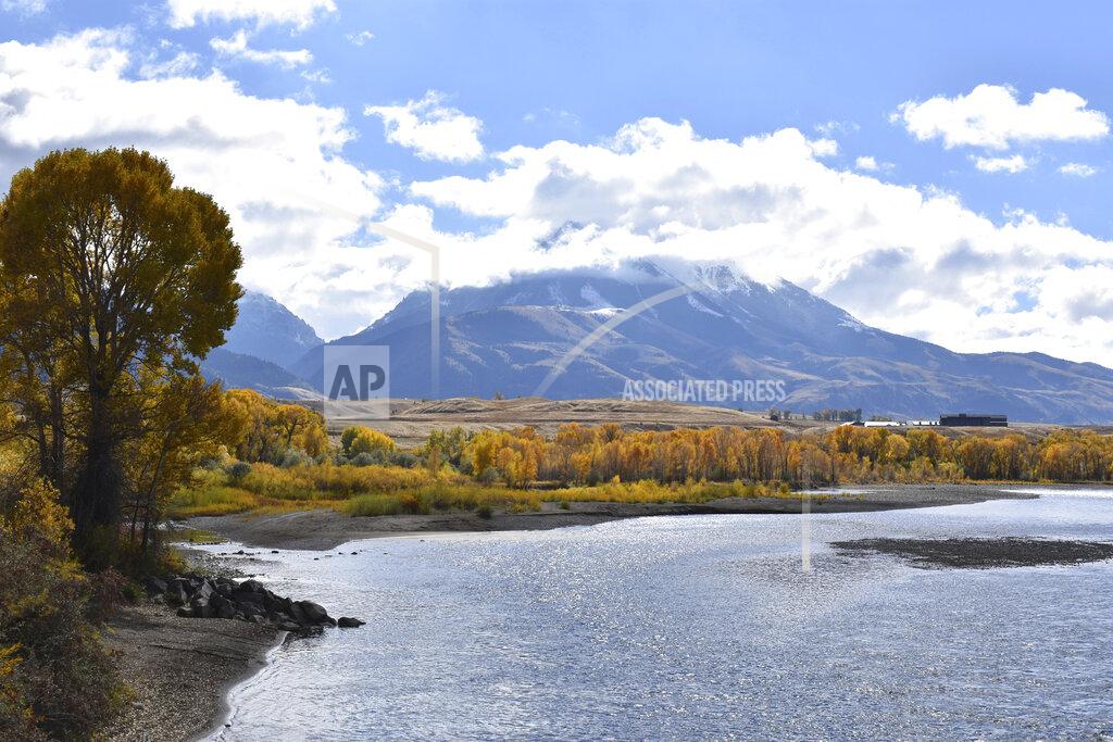 Matthew Brown FILE - In this Oct. 8, 2018 file photo, emigrant Peak is seen rising above the Paradise Valley and the Yellowstone River near Emigrant, Mont. Lawmakers have reached bipartisan agreement on an election-year deal to double spending on a popular conservation program and devote nearly $2 billion a year to improve and maintain national parks. (AP Photo/Matthew Brown, File)