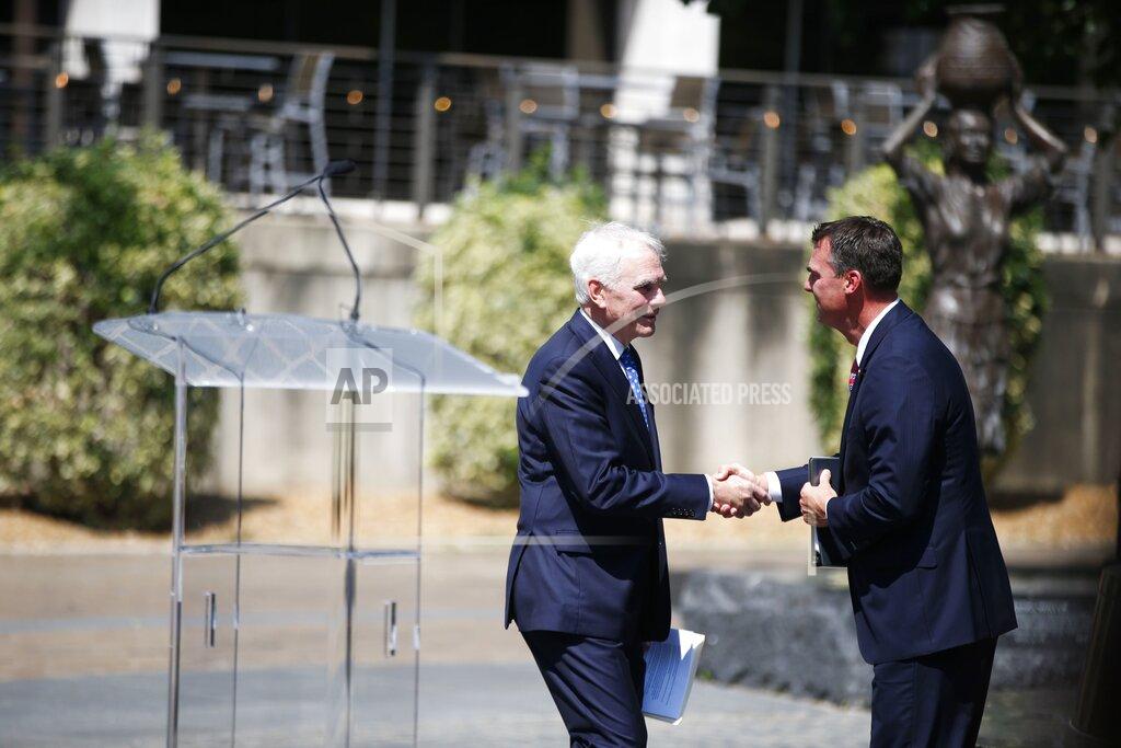 Michael Noble Jr. Oklahoma Gov. Kevin Stitt, right, shakes hands with, John O'Connor after appointing O'Connor as Oklahoma's Attorney General on Friday, July 23, 2021, in Tulsa, Okla. O'Connor fills a vacancy left in May when former Attorney General Mike Hunter stepped down suddenly. (Michael Noble Jr./Tulsa World via AP)