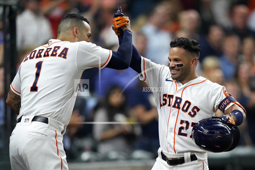 David J. Phillip Houston Astros' Jose Altuve (27) celebrates with Carlos Correa (1) after hitting a home run against the Chicago White Sox during the sixth inning of a baseball game Thursday, June 17, 2021, in Houston. (AP Photo/David J. Phillip)