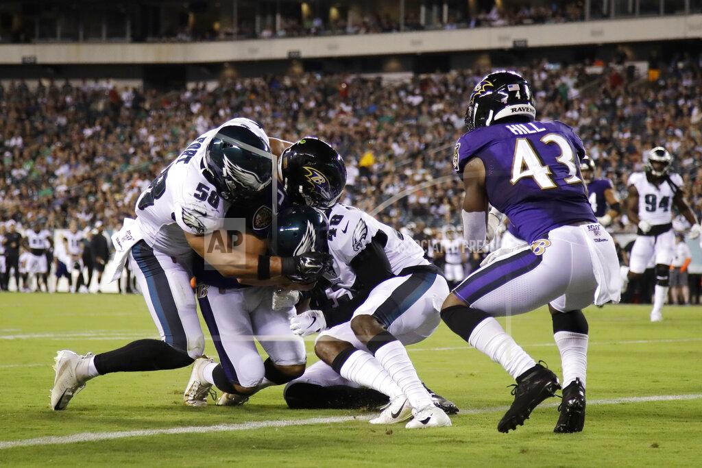 Matt Rourke Baltimore Ravens' Trace McSorley (7) scores a touchdown against Philadelphia Eagles' L.J. Fort (58) and Josh Hawkins (48) during the first half of a preseason NFL football game Thursday, Aug. 22, 2019, in Philadelphia. (AP Photo/Matt Rourke)