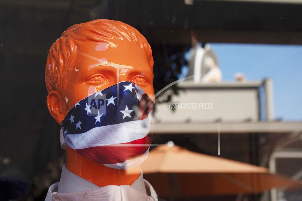 Jae C. Hong FILE - In this Thursday, July 2, 2020 file photo, a mannequin wears a face mask in the window of a store in Commerce, Calif. On Friday, July 10, 2020, The Associated Press reported on stories circulating online incorrectly asserting that wearing a face mask for extended periods of time can cause pleurisy, an inflammation of the lining around the lung. Multiple experts told The Associated Press there is no medical evidence that wearing a face mask could lead to this condition. (AP Photo/Jae C. Hong)