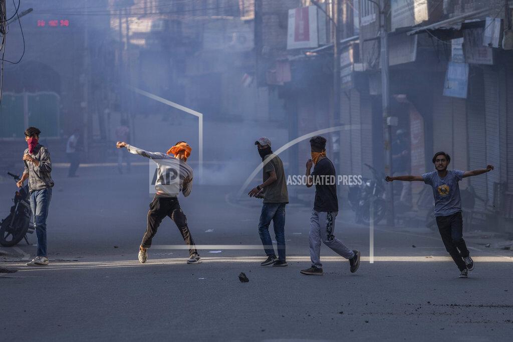 Dar Yasin Protesters clash with security forces during a protest against sentencing of Kashmiri separatist leader Yasin Malik, in Srinagar, Indian controlled Kashmir, Wednesday, May 25, 2022. An Indian court sentenced a Kashmiri separatist leader to life in prison on Wednesday after finding him guilty of terrorism and sedition, triggering a clash between protesters and police and a partial shutdown of businesses in the Indian-controlled portion of disputed Kashmir. (AP Photo/Dar Yasin)