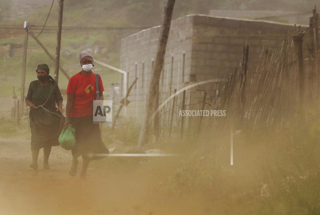 Neo Ntsoma Matefo Litali rushes home to prepare dinner for her family in Maseru, Lesotho, on Friday, Dec. 11, 2020. She starts working at 7 a.m. and finishes by 5 p.m, except on weekends unless she works overtime. While Lesotho’s garment industry might be lesser known compared to the powerhouses of China and Bangladesh, it’s another example of an economy heavily reliant on U.S. demand. (Neo Ntsoma/The Fuller Project via AP)