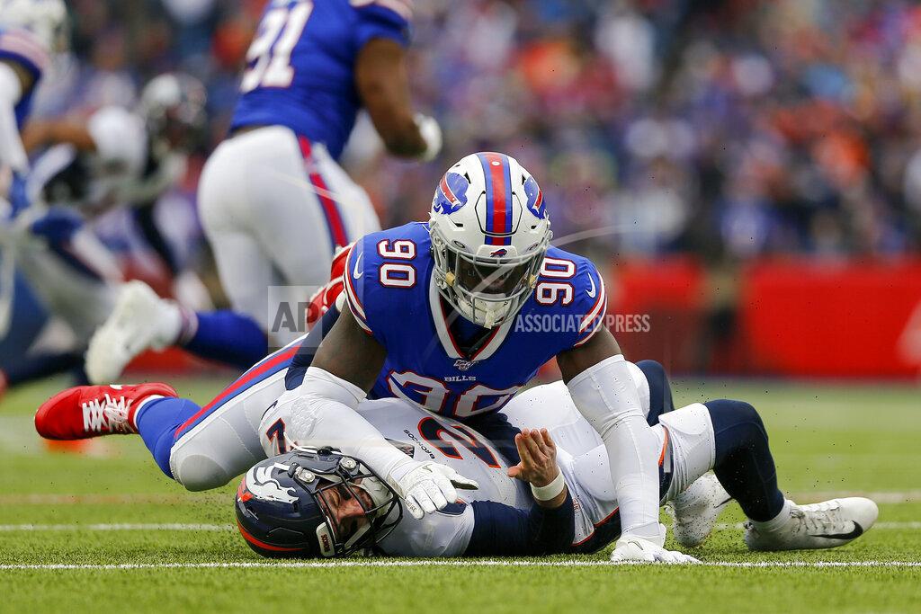 John Munson FILE - In this Nov. 24, 2019, file photo, Buffalo Bills defensive end Shaq Lawson (90) knocks Denver Broncos quarterback Brandon Allen (2) to the ground during the second quarter of an NFL football game in Orchard Park, N.Y. There won’t be any accusations of tanking this year by the Miami Dolphins, who added up to seven starters with a spending spree at the start of free agency. Lawson had a career-high 6 1/2 sacks last year for the Bills. (AP Photo/John Munson, File)
