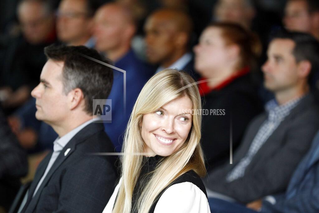 Bob Leverone Chandra Johnson smiles during the retirement announcement by her husband, NASCAR driver Jimmie Johnson near Charlotte, N.C., Thursday, Nov. 21, 2019. (AP Photo/Bob Leverone)