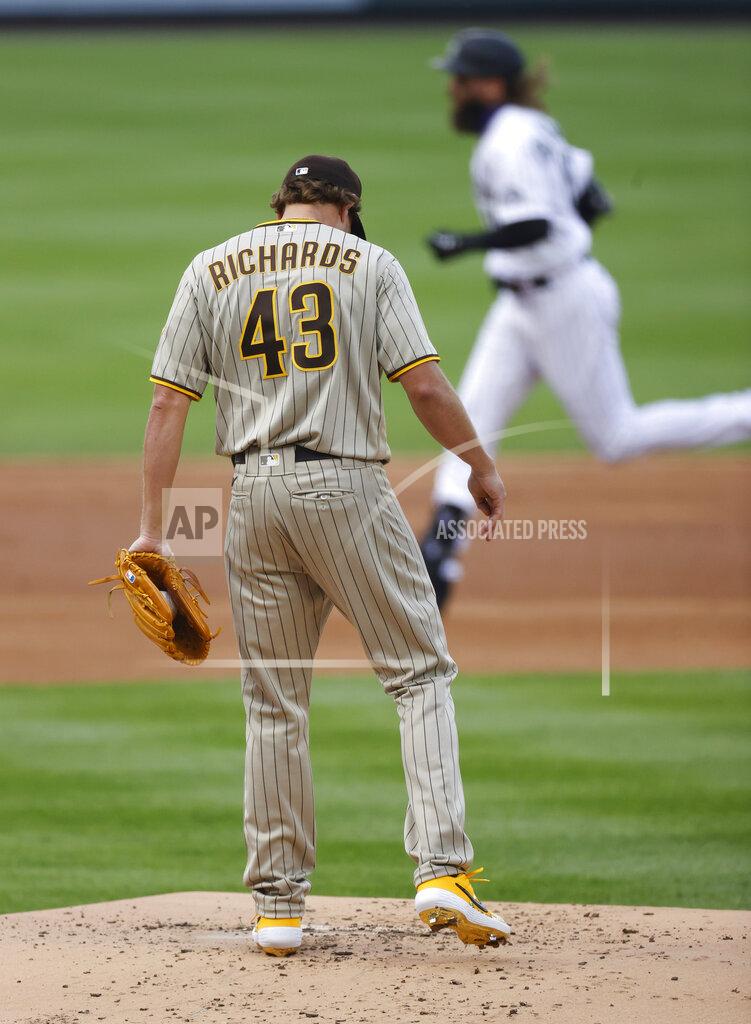 David Zalubowski San Diego Padres starting pitcher Garrett Richards, front, reacts after giving up a two-run home run to Colorado Rockies' Charlie Blackmon, back, in the first inning of a baseball game Friday, July 31, 2020, in Denver. (AP Photo/David Zalubowski)