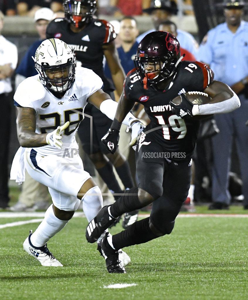 Timothy D. Easley Louisville running back Hassan Hall (19) runs from the pursuit of Georgia Tech defensive back Juanyeh Thomas (28) during the second half of an NCAA college football game, Friday, Oct. 5, 2018, in Louisville, Ky. Georgia Tech won 66-31. (AP Photo/Timothy D. Easley)