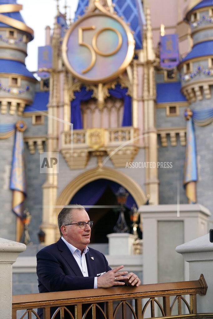 John Raoux George Kalogridis, president of segment development and enrichment for Disney Parks, stands front of the Cinderella Castle at the Magic Kingdom theme park at Walt Disney World Monday, Aug. 30, 2021, in Lake Buena Vista, Fla. Kalogridis was one of 6,000 employees that was working at the theme park on opening day in 1971. (AP Photo/John Raoux)