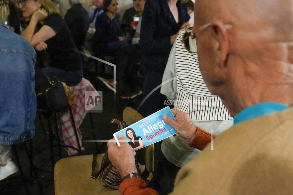 Mark Baker A supporter of Independent candidate for the inner city seat of Wentworth, Allegra Spender, holds a sticker with her photo at a public forum ahead of next weekend's general election in Sydney, Australia on May 16, 2022. Australia's government, considered a laggard on combating climate change, faces a new threat in the form of highly-organized and well-funded independent election candidates who demand deeper cuts on greenhouse gas emissions. (AP Photo/Mark Baker)