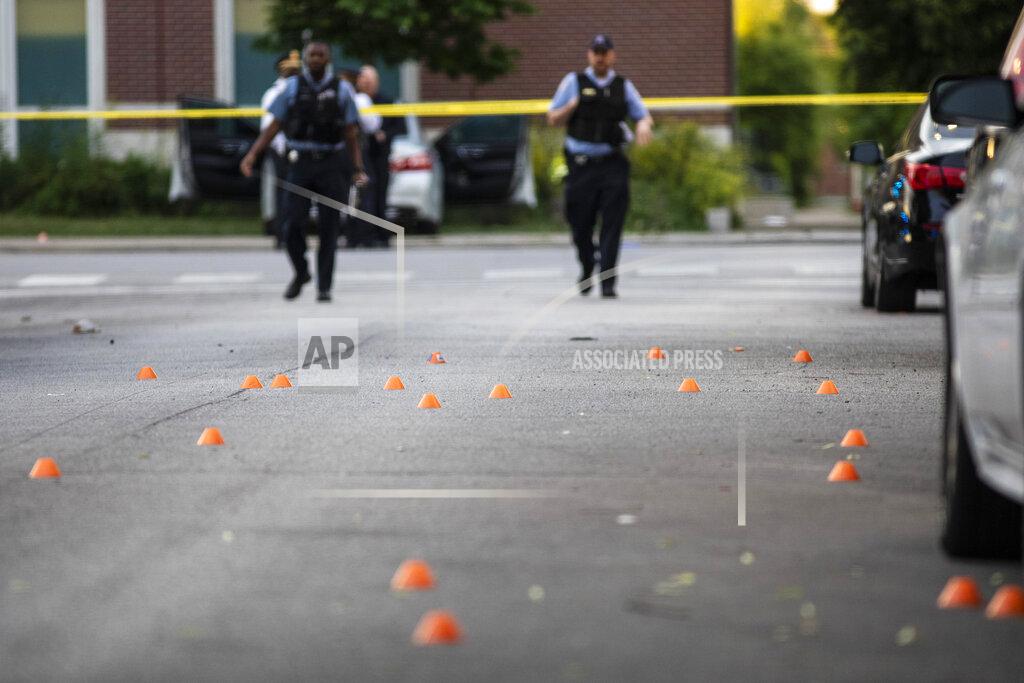 Ashlee Rezin Garcia Chicago police investigate in the 700 block of North Spaulding Avenue, where a 40-year-old man was shot multiple times while he was riding in a car on the West Side on Memorial Day, Monday night, May 31, 2021, in Chicago. (Ashlee Rezin Garcia/Chicago Sun-Times via AP)