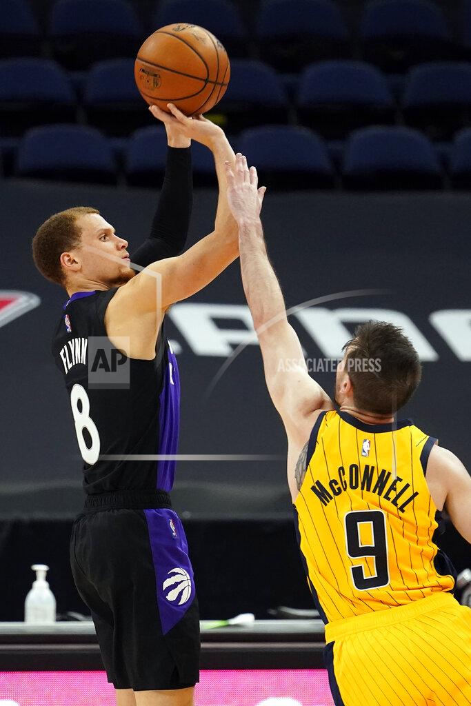 Chris O'meara Toronto Raptors guard Malachi Flynn (8) puts up a three-point shot over Indiana Pacers guard T.J. McConnell (9) during the second half of an NBA basketball game Sunday, May 16, 2021, in Tampa, Fla. (AP Photo/Chris O'Meara)