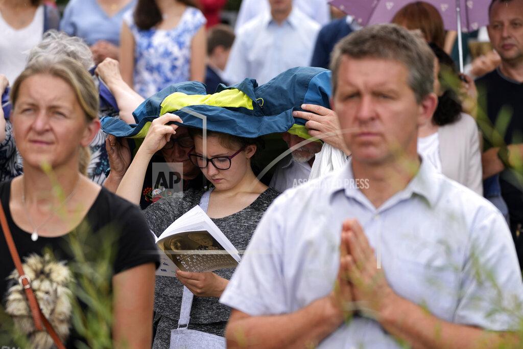 Czarek Sokolowski Catholic faithful attend the beatification ceremony of Polish Cardinal Stefan Wyszynski and Mother Elzbieta Roza Czacka in front of the church of Providence in Warsaw, Poland, Sunday, Sept. 12, 2021. Poland's top political leaders gathered in a Warsaw church Sunday for the beatification of two revered figures of the Catholic church — a cardinal who led the Polish church's resistance to communism and a blind nun who devoted her life to helping others who couldn't see. (AP Photo/Czarek Sokolowski)