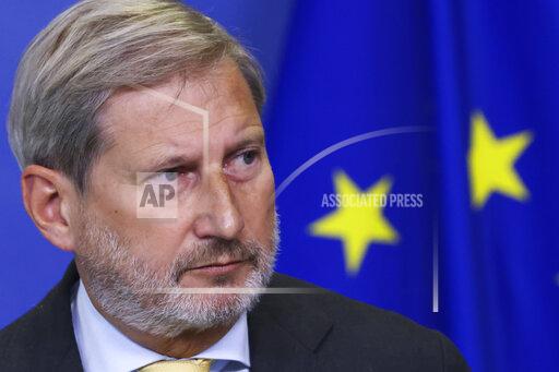 European Commissioner for Budget and Administration Johannes Hahn addresses a media conference on Next Generation EU green bonds at EU headquarters in Brussels, Tuesday, Oct. 12, 2021. The European Commission issued its inaugural green bonds Tuesday, raising 12 billion euros from a sale that attracted strong demands from investors. The EU's executive branch is planning to issue up to 250 billion euros in green bonds by the end of 2026 as part of its plans to finance the 27-nation bloc's recovery from the coronavirus crisis. (Yves Herman, Pool Photo via AP)