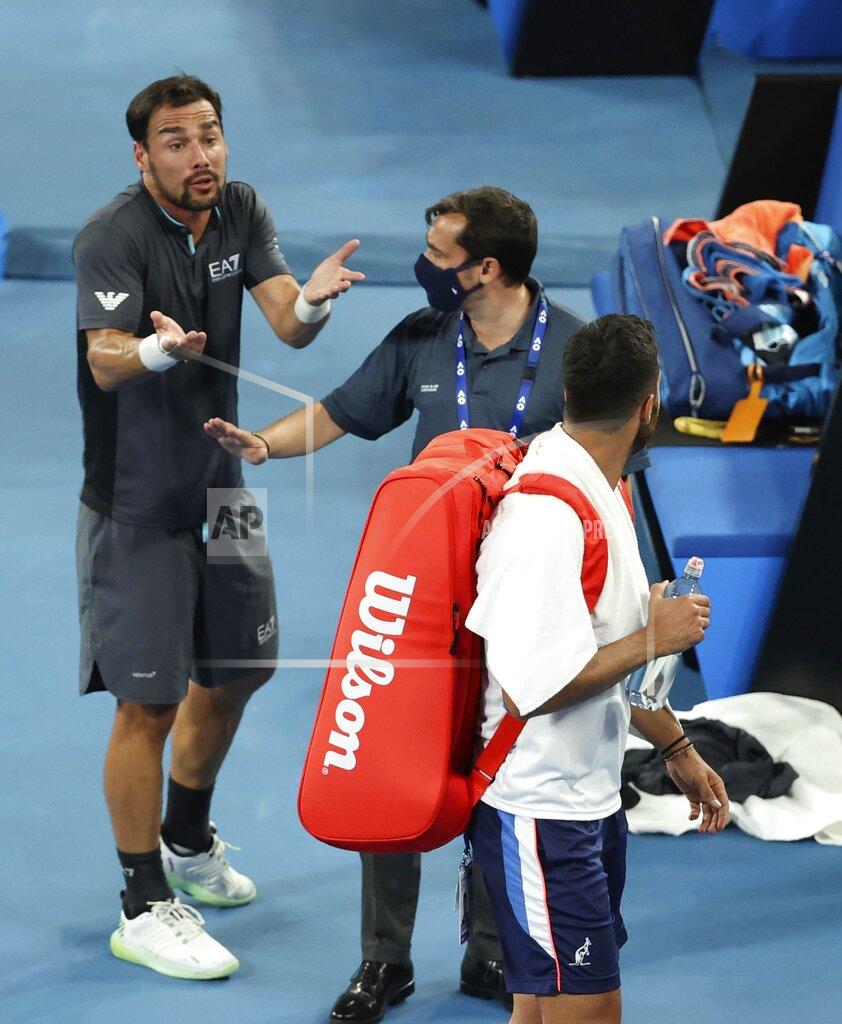 Hamish Blair Italy's Fabio Fognini, left, speaks as compatriot Salvatore Caruso walks away after their second round match at the Australian Open tennis championship in Melbourne, Australia, Thursday, Feb. 11, 2021. Fognini won the match. (AP Photo/Hamish Blair)
