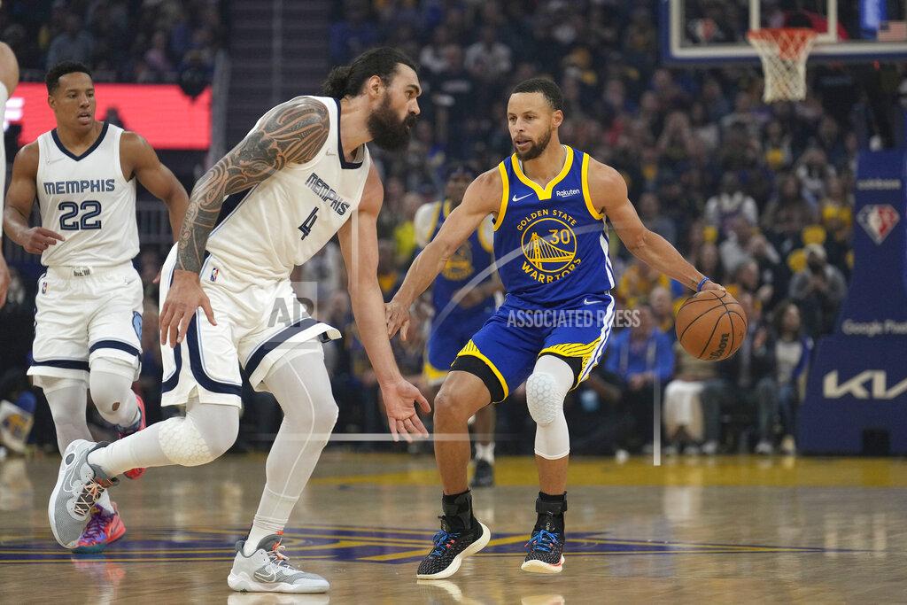 Tony Avelar Golden State Warriors guard Stephen Curry (30) dribbles around Memphis Grizzlies center Steven Adams (4) during the first half of Game 6 of an NBA basketball Western Conference playoff semifinal in San Francisco, Friday, May 13, 2022. (AP Photo/Tony Avelar)