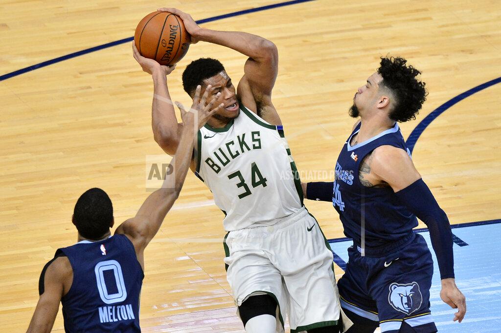 Brandon Dill Milwaukee Bucks forward Giannis Antetokounmpo (34) handles the ball between Memphis Grizzlies guards De'Anthony Melton (0) and Dillon Brooks (24) in the first half of an NBA basketball game Thursday, March 4, 2021, in Memphis, Tenn. (AP Photo/Brandon Dill)