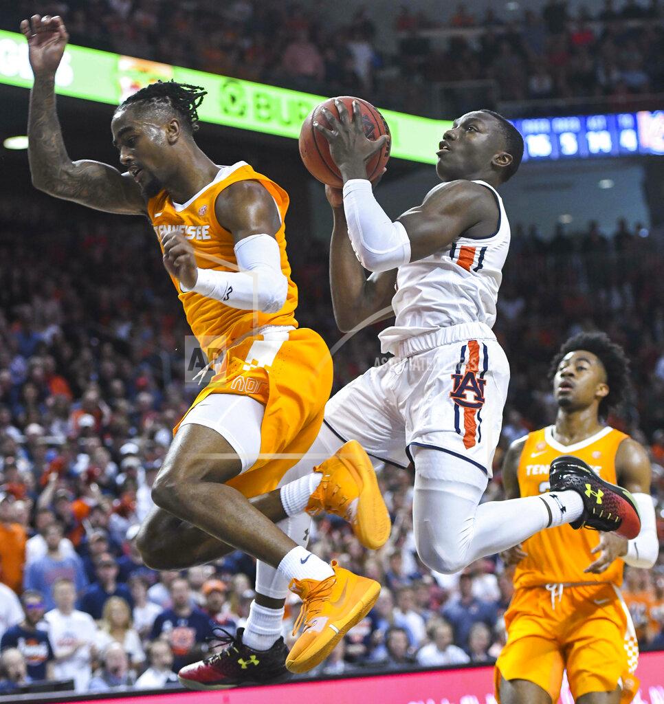 Auburn guard Jared Harper (1) collides with Tennessee guard Jordan Bone (0) on his way to the basket during the second half of an NCAA college basketball game Saturday, March 9, 2019, in Auburn, Ala. (AP Photo/Julie Bennett)