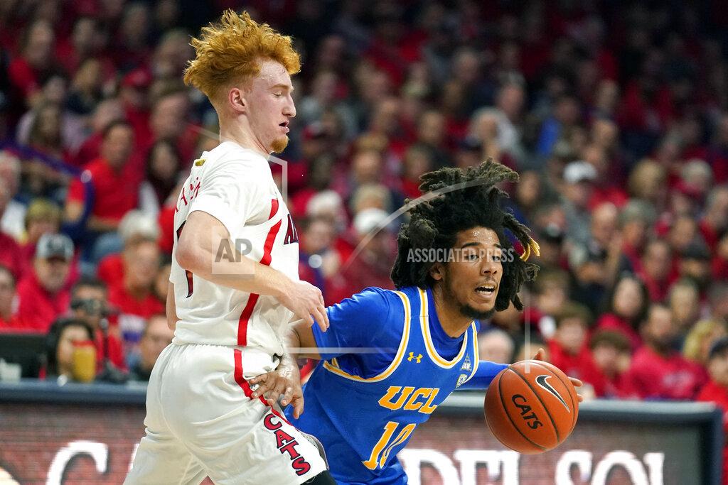 Rick Scuteri UCLA guard Tyger Campbell (10) drives on Arizona guard Nico Mannion during the first half of an NCAA college basketball game Saturday, Feb. 8, 2020, in Tucson, Ariz. (AP Photo/Rick Scuteri)