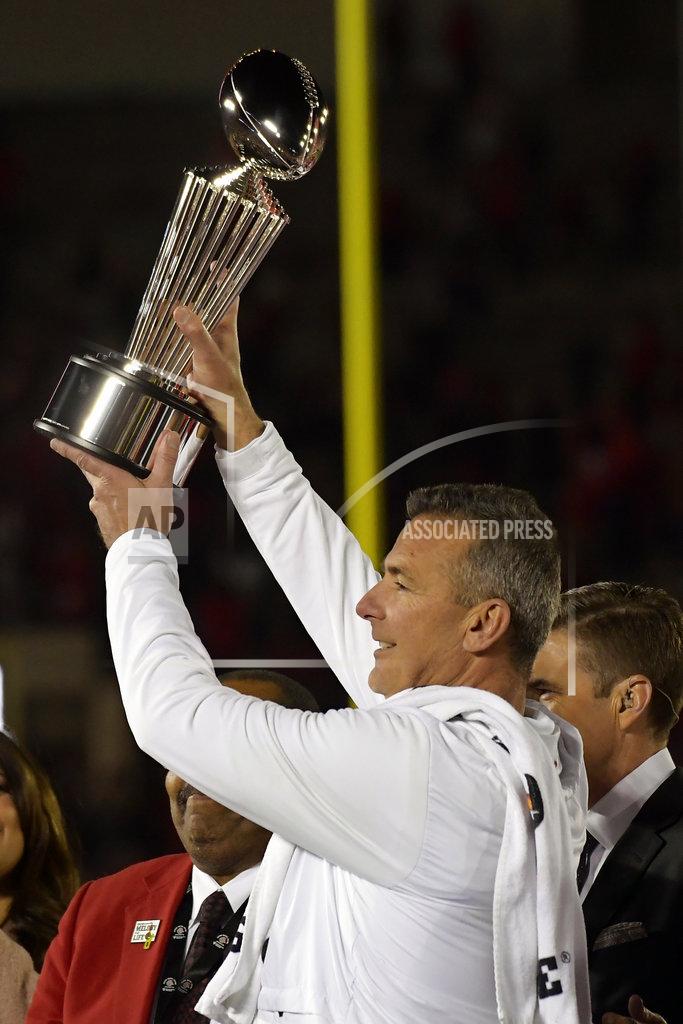 Mark J. Terrill Ohio State coach Urban Meyer holds up the trophy after Ohio State defeated Washington 28-23 during the Rose Bowl NCAA college football game Tuesday, Jan. 1, 2019, in Pasadena, Calif. (AP Photo/Mark J. Terrill)