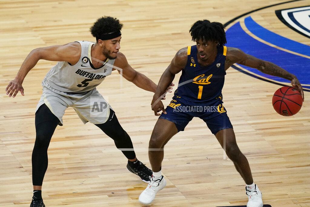 John Locher California's Joel Brown (1) drives into Colorado's D'Shawn Schwartz (5) during the first half of an NCAA college basketball game in the quarterfinal round of the Pac-12 men's tournament Thursday, March 11, 2021, in Las Vegas. (AP Photo/John Locher)