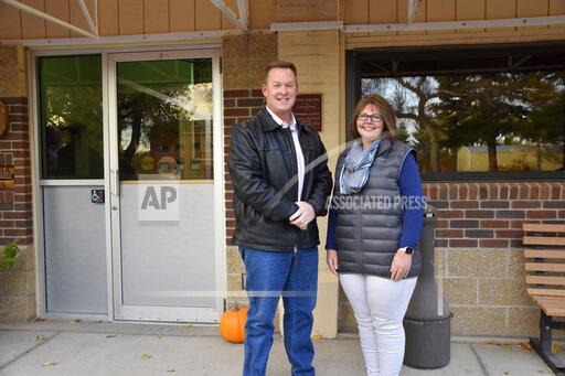 Ken and Kelly Speidel stand outside the community hall of Cascade, Mont., Friday, Oct. 15, 2021. The Speidels own a horse boarding business in Cascade, a rural community on the banks of the Missouri River. For the first time in 30 years, the Census has awarded Montana a second seat in Congress and a commission is being tasked with determining how to divide the state into two congressional districts. (AP Photo/Iris Samuels)