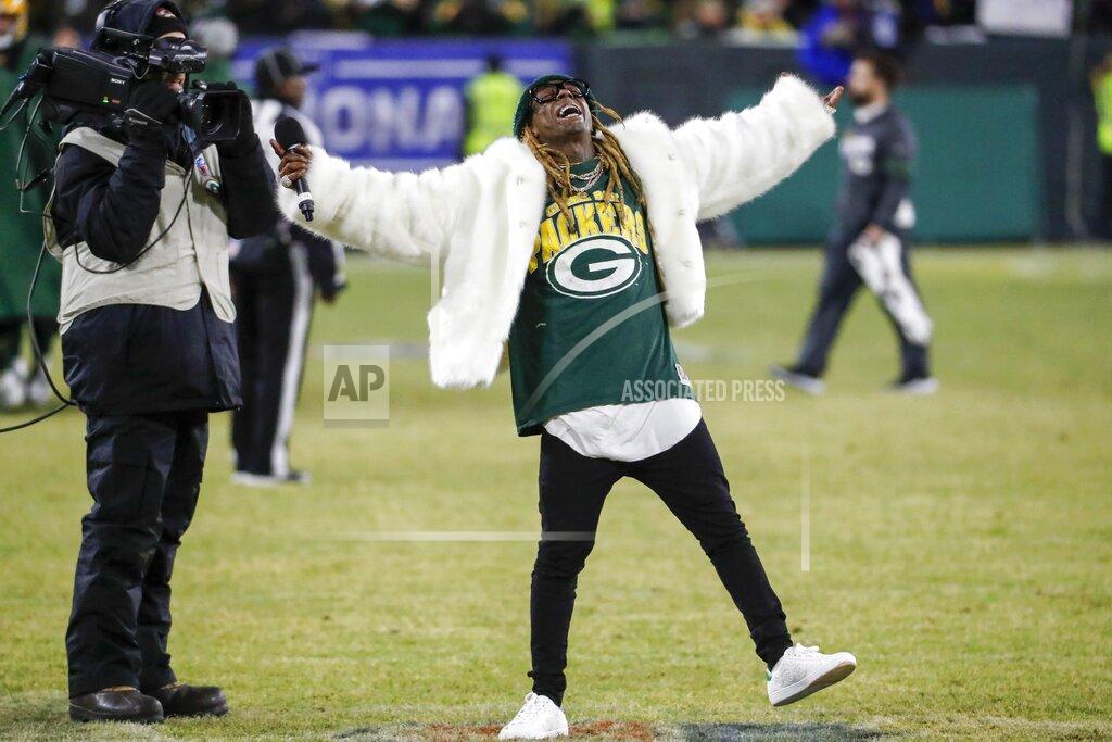 Matt Ludtke Rapper Lil Wayne sings during a break during the second half of an NFL divisional playoff football game between the Green Bay Packers and the Seattle Seahawks Sunday, Jan. 12, 2020, in Green Bay, Wis. (AP Photo/Matt Ludtke)