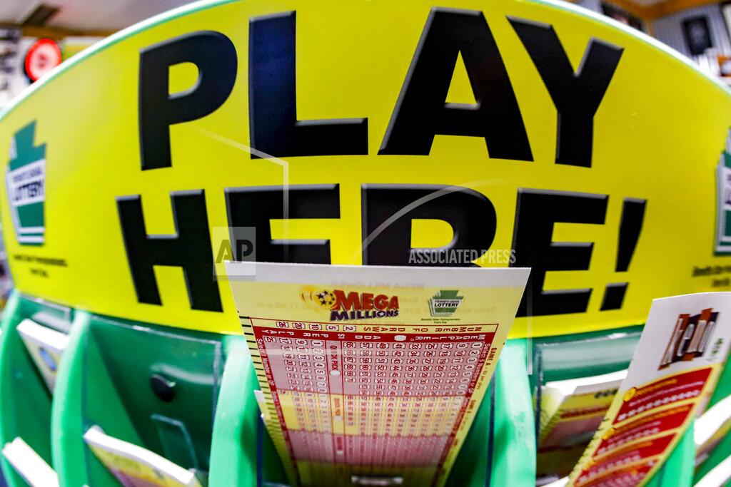 Keith Srakocic A Mega Millions playslip for those players preferring to choose the numbers they want to play is among the stacks of other lottery game playslips on display at a Smoker Friendly store, Friday, Jan. 22, 2021, in Cranberry Township, Pa. The jackpot for the Mega Millions lottery game has grown to $1 billion ahead of Friday night's drawing after more than four months without a winner.(AP Photo/Keith Srakocic)
