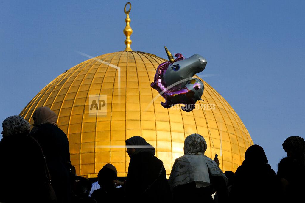 Mahmoud Illean Palestinians gather for Eid al-Adha prayer next to the Dome of the Rock Mosque in the Al Aqsa Mosque compound in Jerusalem's Old City, Tuesday, July 20, 2021. (AP Photo/Mahmoud Illean)