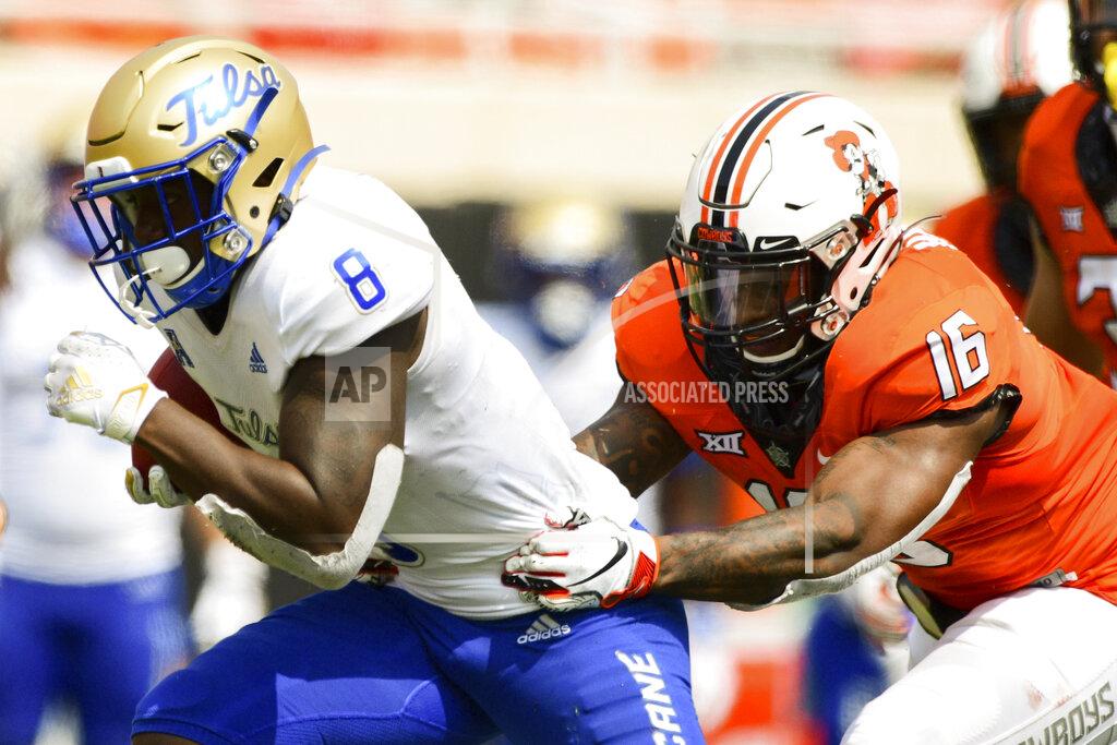 Brody Schmidt Tulsa running back Deneric Prince (8) struggles to escape Oklahoma State cornerback Rodarius Williams (16) in the second half of an NCAA college football game Saturday, Sept. 19, 2020, in Stillwater, Okla. (AP Photo/Brody Schmidt)
