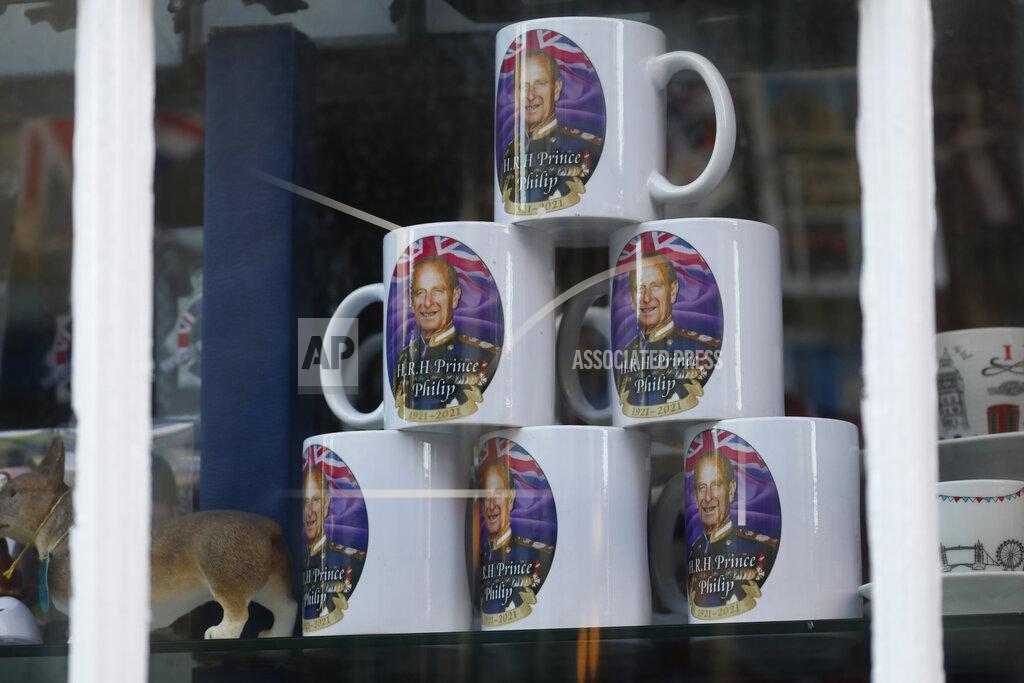 Alastair Grant Memorabilia mugs showing a photograph of Britain's Prince Philip on sale at a shop in Windsor, England, Friday, April 16, 2021. Prince Philip husband of Britain's Queen Elizabeth II died April 9, aged 99, his funeral will take place Saturday at Windsor Castle in St George's Chapel. (AP Photo/Alastair Grant)