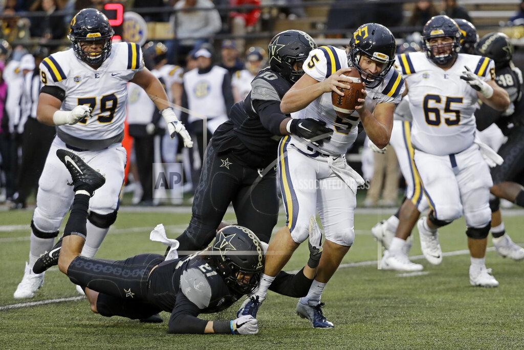 Mark Humphrey ETSU quarterback Trey Mitchell (5) is sacked by Vanderbilt linebacker Kenny Hebert (21) and defensive lineman Dayo Odeyingbo (10) in the first half of an NCAA college football game Saturday, Nov. 23, 2019, in Nashville, Tenn. (AP Photo/Mark Humphrey)