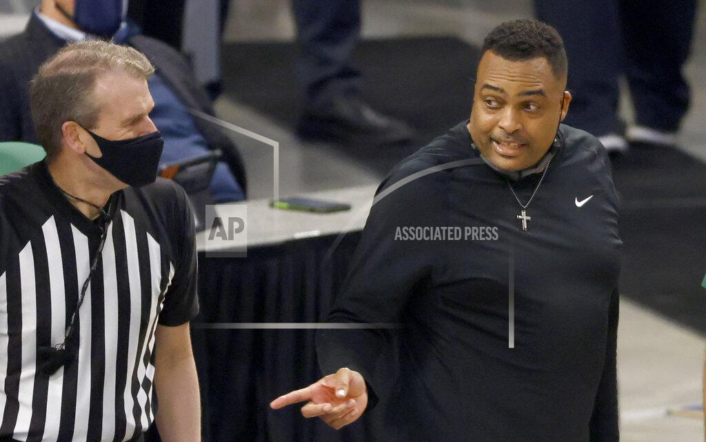 Ron Jenkins Tulane head coach Ron Hunter, right, talks with a game official as Tulane plays Houston during the second half of an NCAA college basketball game in the quarterfinal round of the American Athletic Conference men's tournament Friday, March 12, 2021, in Fort Worth, Texas. (AP Photo/Ron Jenkins)