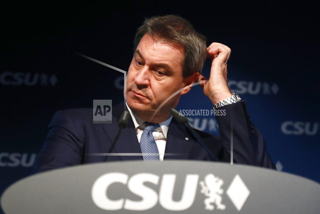 Matthias Schrader File - In this Monday, Oct. 15, 2018 file photo Bavarian governor Markus Soeder listens during a press conference at the headquarters of the Christian Social Union, CSU, in Munich. German Chancellor Angela Merkel's center-right party, the Christian Democratic Union, CDU, is choosing a new leader on the weekend Saturday Jan. 16 and Sunday Jan. 17, 2021, a decision that will help determine who succeeds Merkel at the helm of the European Union's biggest economy after a 16-year reign. (AP Photo/Matthias Schrader, file)