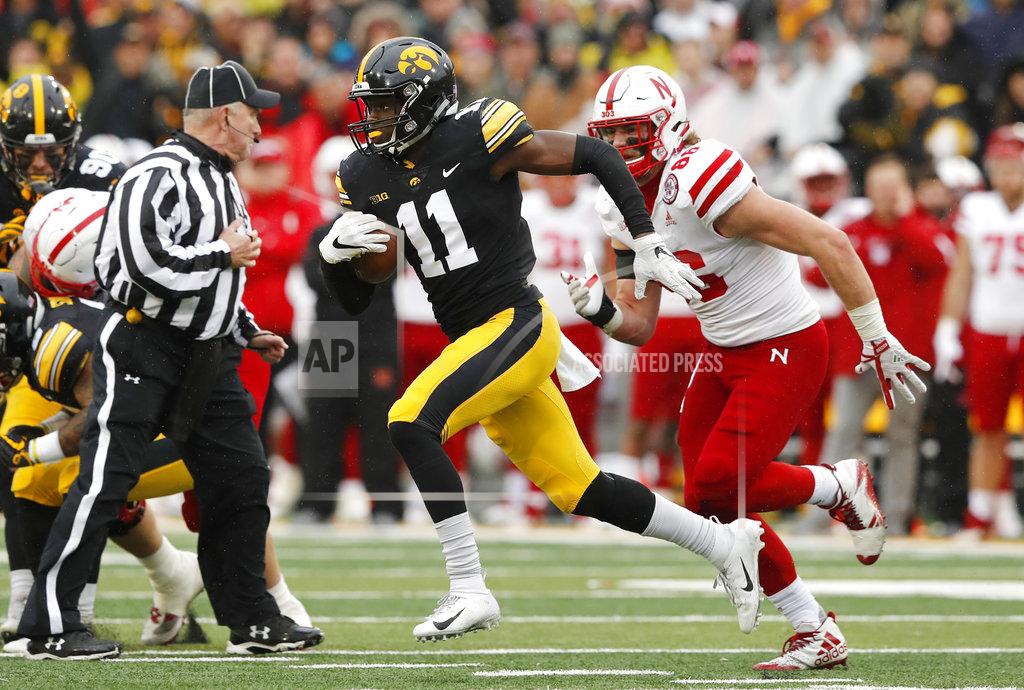 Charlie Neibergall Iowa defensive back Michael Ojemudia (11) runs from Nebraska tight end Jack Stoll, right, after intercepting a pass during the second half of an NCAA college football game, Friday, Nov. 23, 2018, in Iowa City, Iowa. Iowa won 31-28. (AP Photo/Charlie Neibergall)