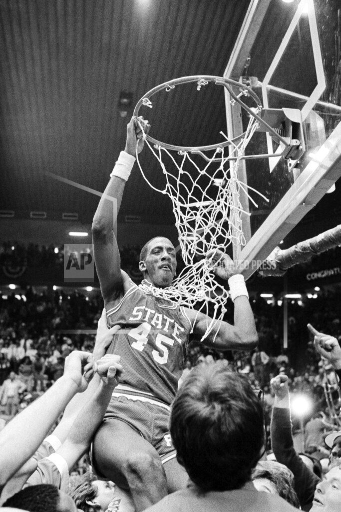 Anonymous FILE - In this April 4, 1983, file photo, North Carolina State center Cozell McQueen goes after the net during the victory celebration after defeating Houston 54-52 to win the NCAA college basketball championship in Albuquerque, N.M. (AP Photo/File)