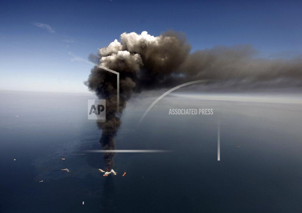 Gerald Herbert FILE - This April 21, 2010 file photo shows oil in the Gulf of Mexico, more than 50 miles southeast of Venice on Louisiana's tip, as the Deepwater Horizon oil rig burns. Ten years after an oil rig explosion killed 11 workers and unleashed an environmental nightmare in the Gulf of Mexico, companies are drilling into deeper and deeper waters where the payoffs can be huge but the risks are greater than ever. (AP Photo/Gerald Herbert, File)