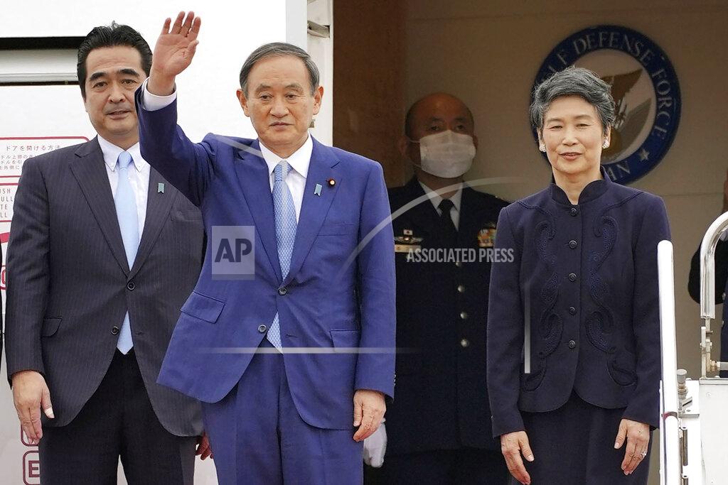 Shigeyuki Inakuma Japan’s Prime Minister Yoshihide Suga, second left, and his wife Mariko prepare to leave Haneda airport in Tokyo Sunday, Oct. 19, 2020. Suga left Sunday on his first overseas foray since taking over from his former boss Shinzo Abe last month, heading to Vietnam and Indonesia. (Shigeyuki Inakuma/Kyodo News via AP)