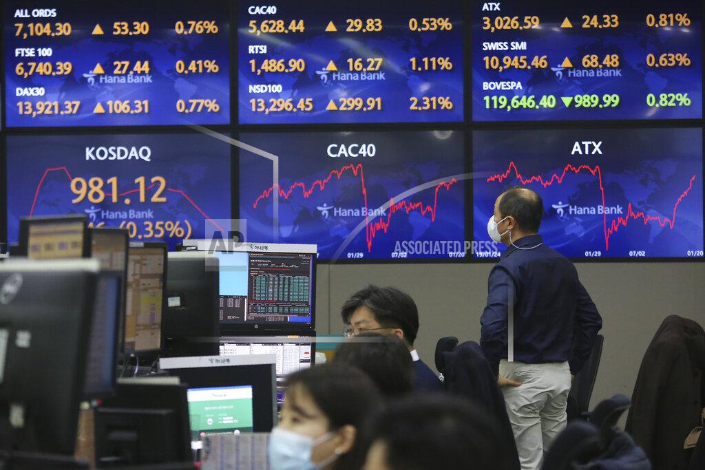 Ahn Young-Joon A currency trader watches the screens showing the foreign exchange rates at the foreign exchange dealing room of the KEB Hana Bank headquarters in Seoul, South Korea, Thursday, Jan. 21, 2021. Asian shares rose Thursday on optimism over the new U.S. administration that earlier set off a rally on Wall Street. (AP Photo/Ahn Young-joon)